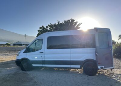 Carlos parked by tropical trees—Big Island camper van rental