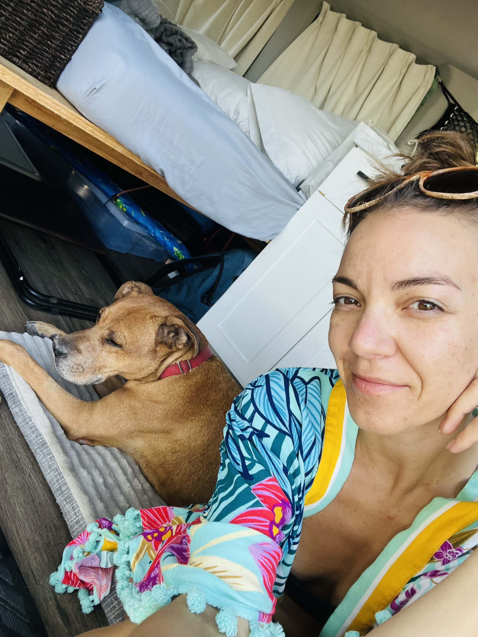 campervan_host woman wearing a brightly coloured shawl sitting next to her dog